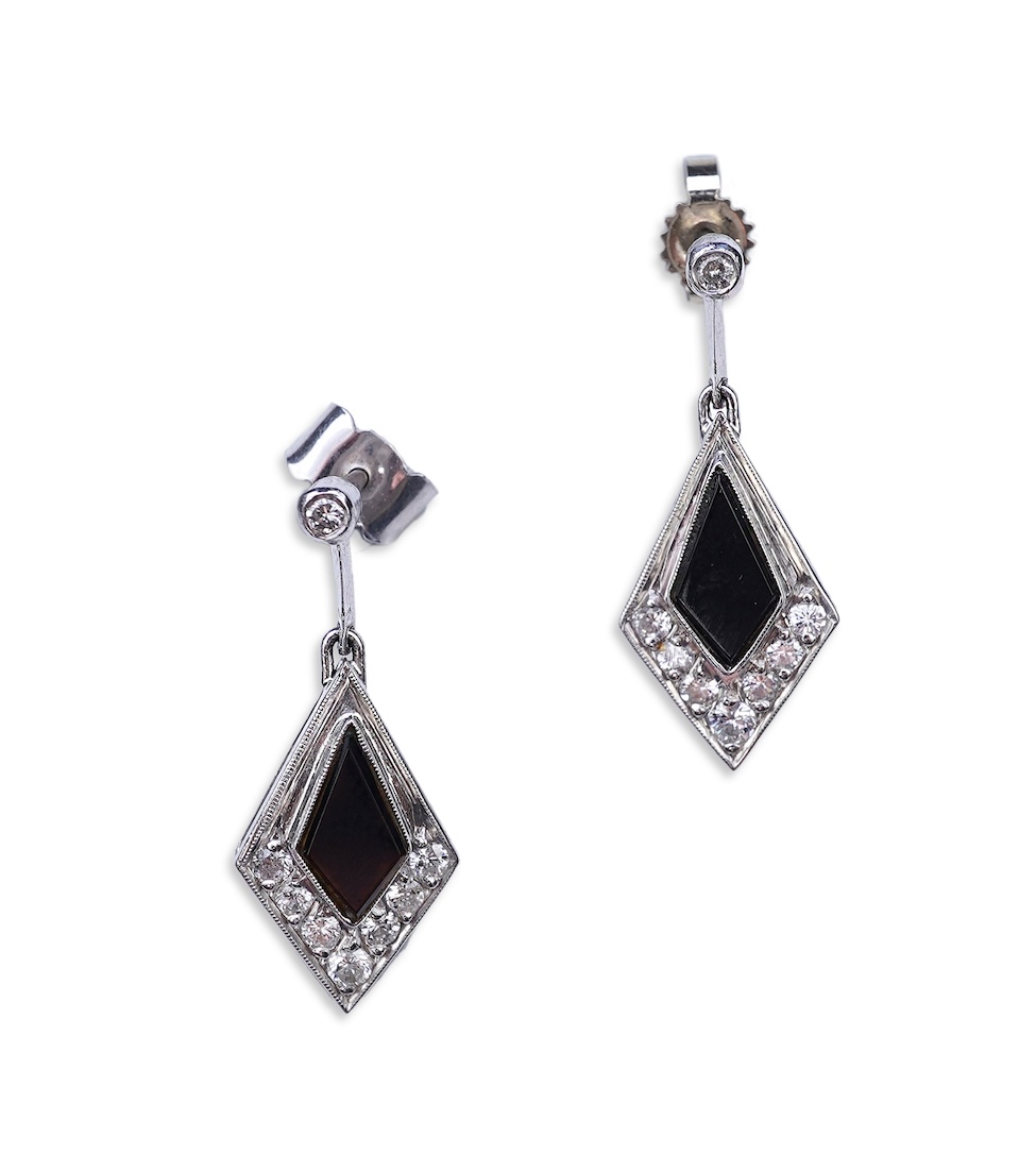 A pair of onyx and diamond earrings
